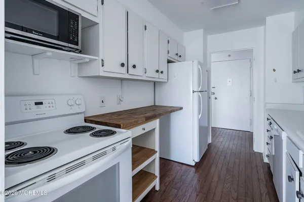 a bedroom with a bed and dresser with mirror