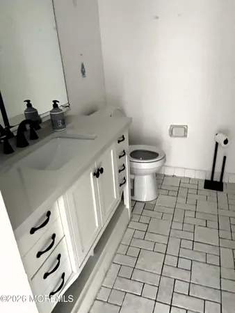 a view of an entryway with a flower pot and a bookshelf