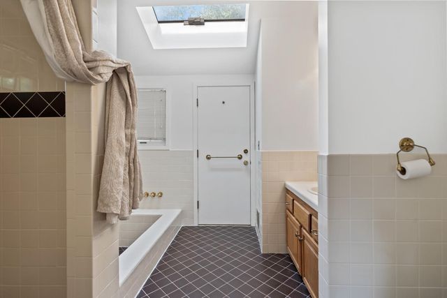 a bathroom with a bathtub and shower