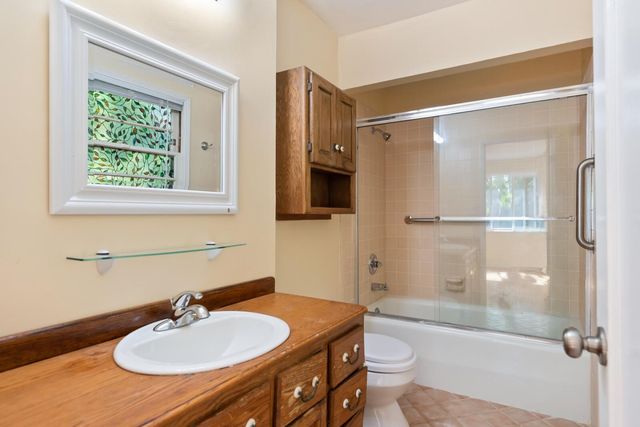 a bathroom with a sink toilet tub and shower