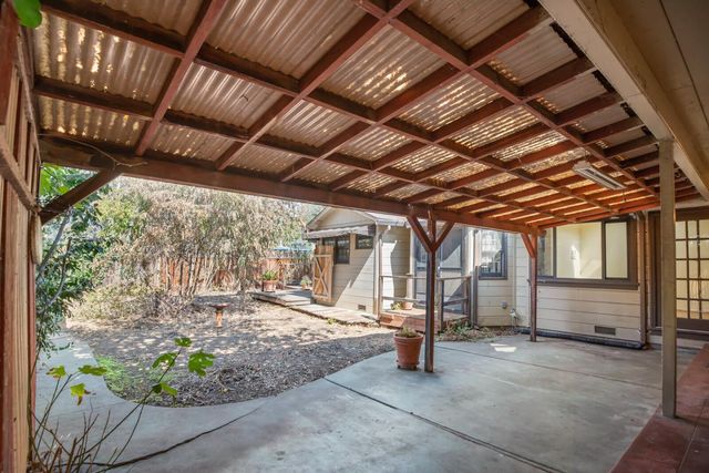 a view of a porch with furniture and a backyard