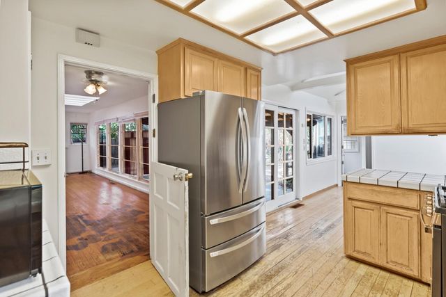 a kitchen with stainless steel appliances granite countertop a refrigerator and a stove