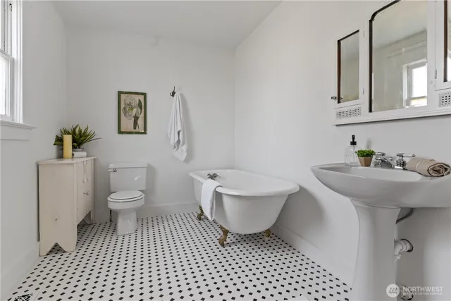 a bathroom with a sink a toilet and a mirror