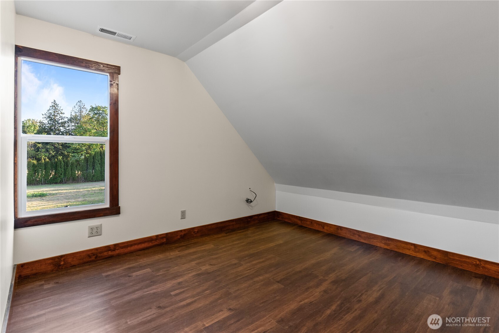 1371 West Axton Road Ferndale, WA 98248 - Photo 29 of 40 a view of an empty room with wooden floor and a window