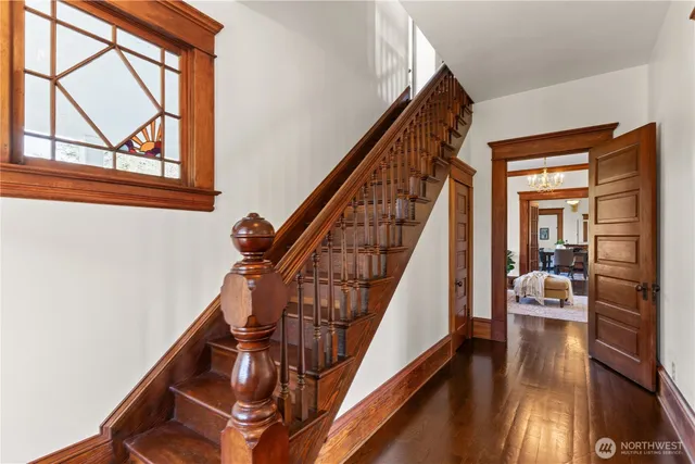 a view of entryway and hall with wooden floor