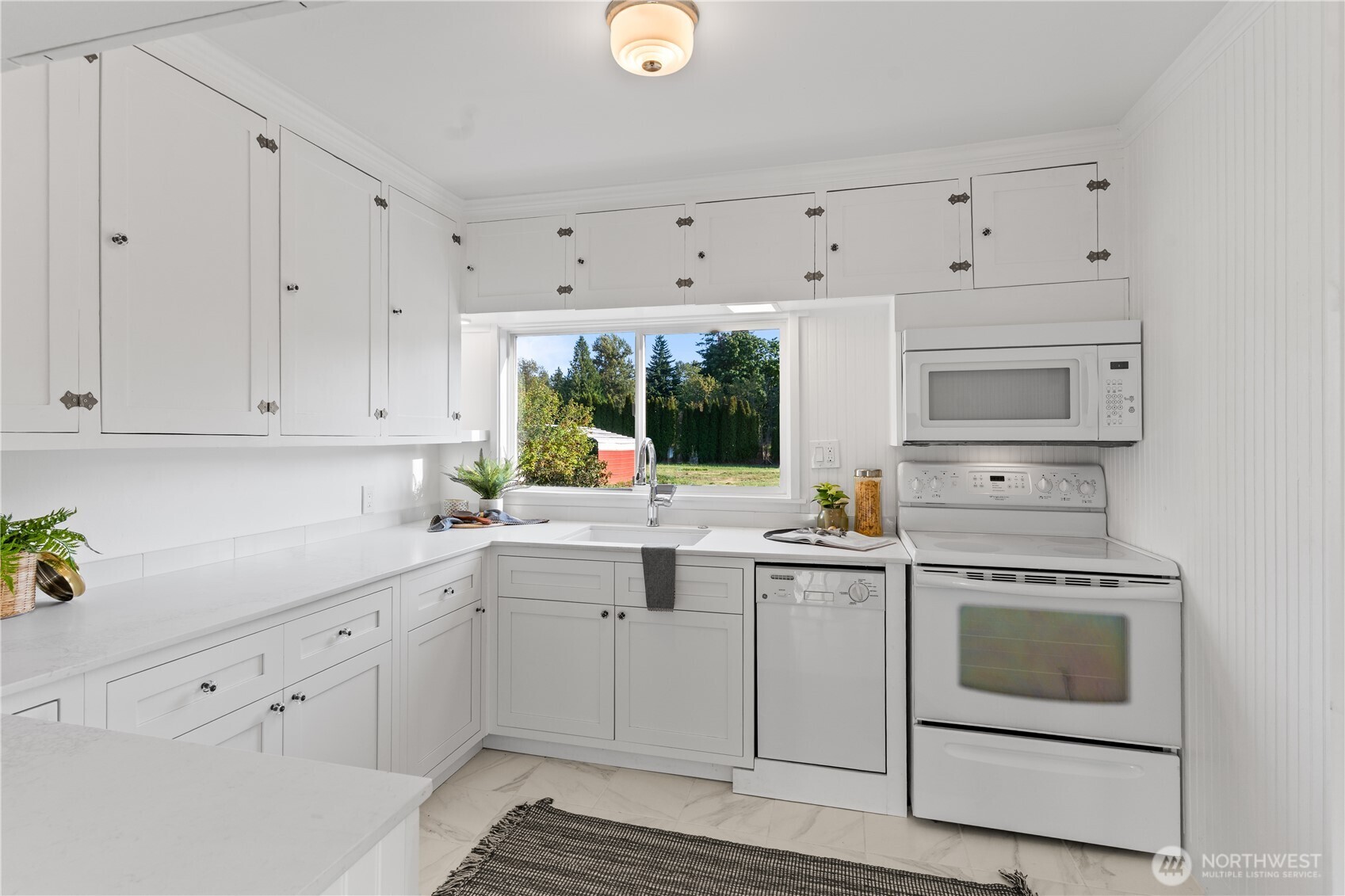 1371 West Axton Road Ferndale, WA 98248 - Photo 9 of 40 a kitchen with white cabinets stainless steel appliances and sink