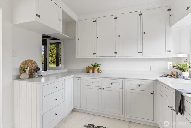 a kitchen with white cabinets and a sink