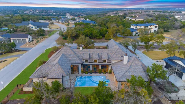 an aerial view of house with a garden