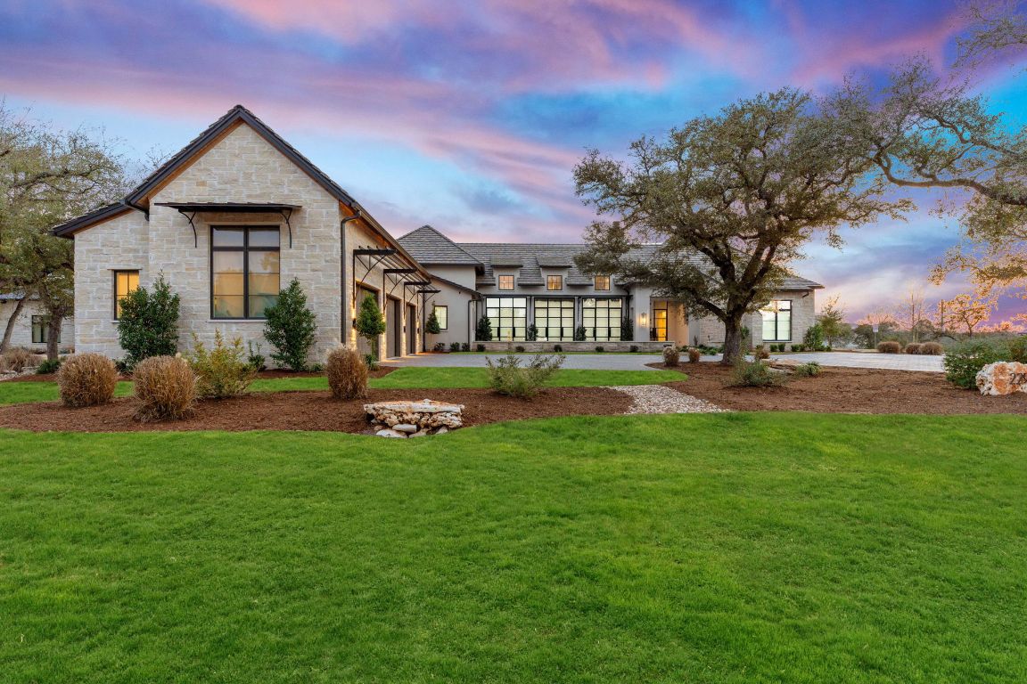 229 Tiffanie Way Austin, TX 78737 - Photo 5 of 40 Back of house featuring stone siding and a yard