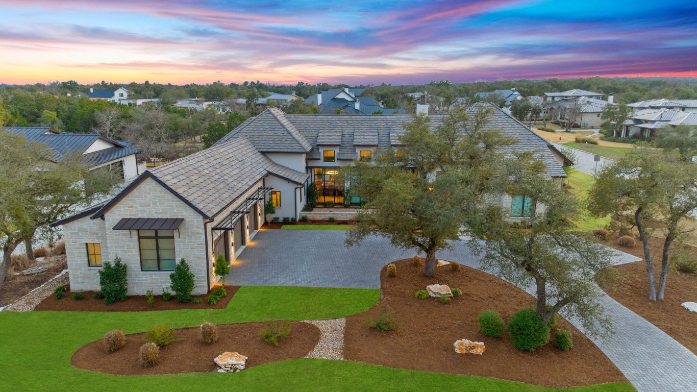 229 Tiffanie Way Austin, TX 78737 - Photo 6 of 40 View of front of property with stone siding, a yard, curved driveway, stucco siding, and a residential view