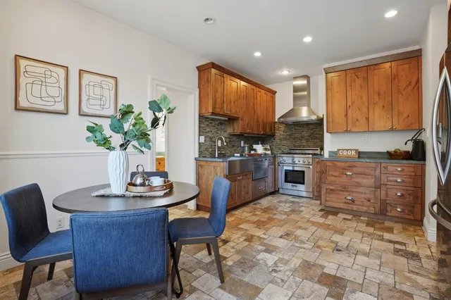 a kitchen with a table chairs and a refrigerator