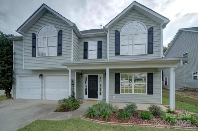 a view of a brick house with large windows