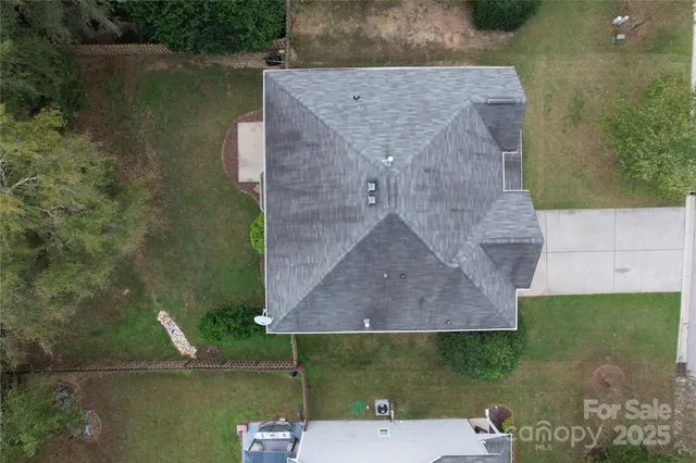 an aerial view of a house with a yard