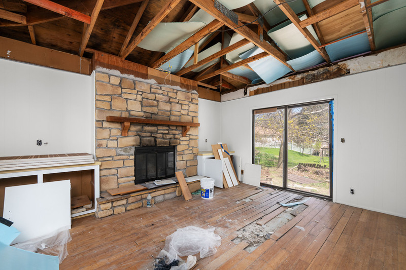 2416 7th Street Moline, IL 61265 - Photo 13 of 27 a view of a livingroom with wooden floor a fireplace and windows