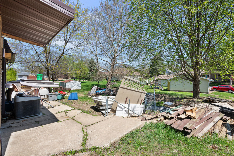2416 7th Street Moline, IL 61265 - Photo 25 of 27 a view of a patio with couches and table and chairs and potted plants