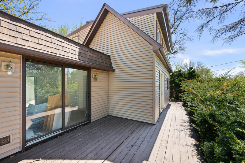 2416 7th Street Moline, IL 61265 - Photo 7 of 27 a view of a balcony with wooden floor and floor to ceiling window