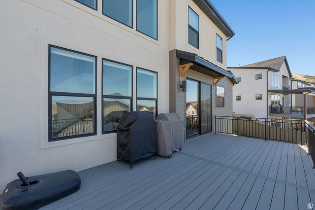 1711 West Canyon Rim Road North Lehi, UT 84048 - Photo 25 of 31 Spacious outdoor deck featuring composite decking, black metal railings, and a sliding glass door