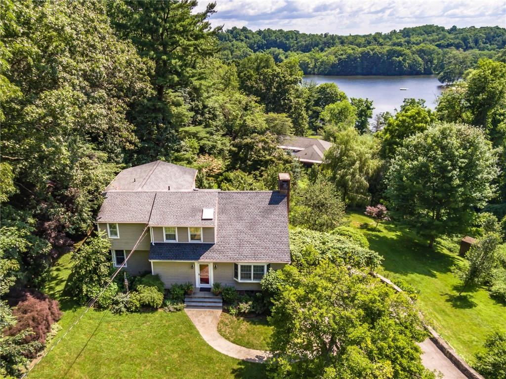 an aerial view of a house with pool and a yard