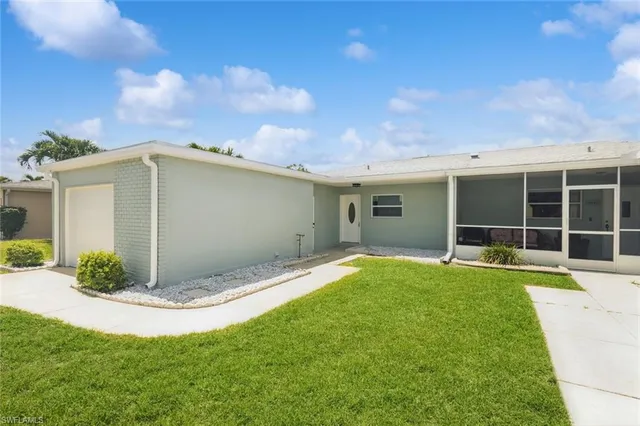 a view of a backyard with potted plants and a large window