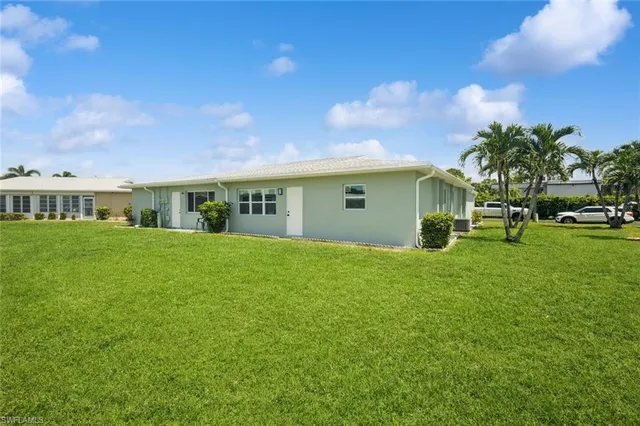 a view of house with backyard