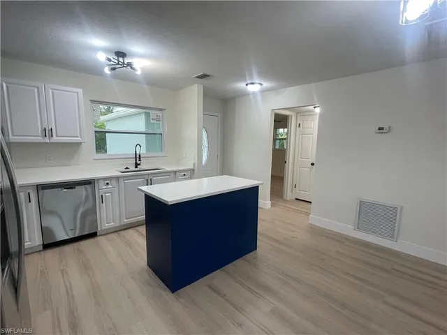 a kitchen with wooden cabinets and sink