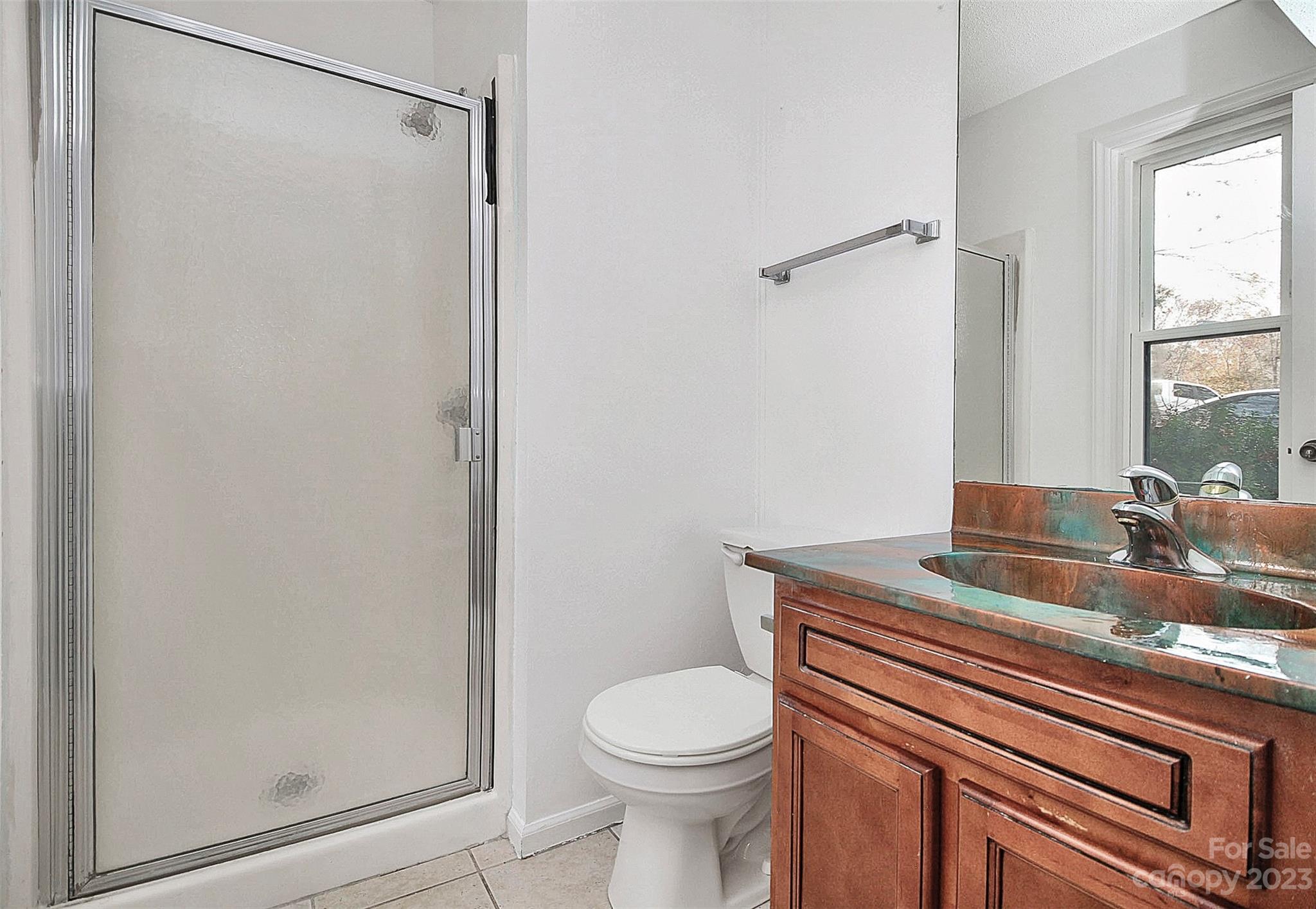 27051 Catamaran Drive Tega Cay, SC 29708 - Photo 17 of 35 a bathroom with a granite countertop sink toilet and shower