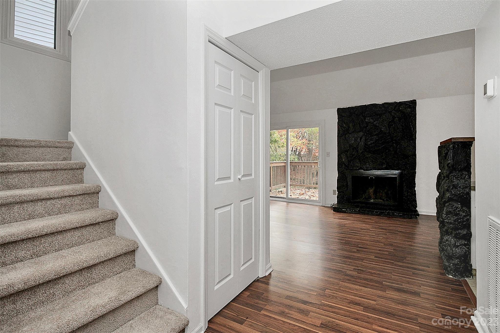 27051 Catamaran Drive Tega Cay, SC 29708 - Photo 18 of 35 a view of an entryway with wooden floor and a fireplace