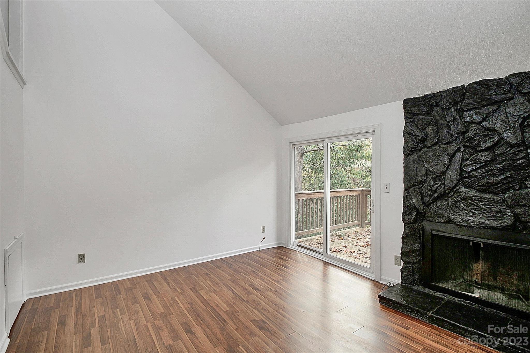 27051 Catamaran Drive Tega Cay, SC 29708 - Photo 19 of 35 wooden floor in an empty room with a fireplace