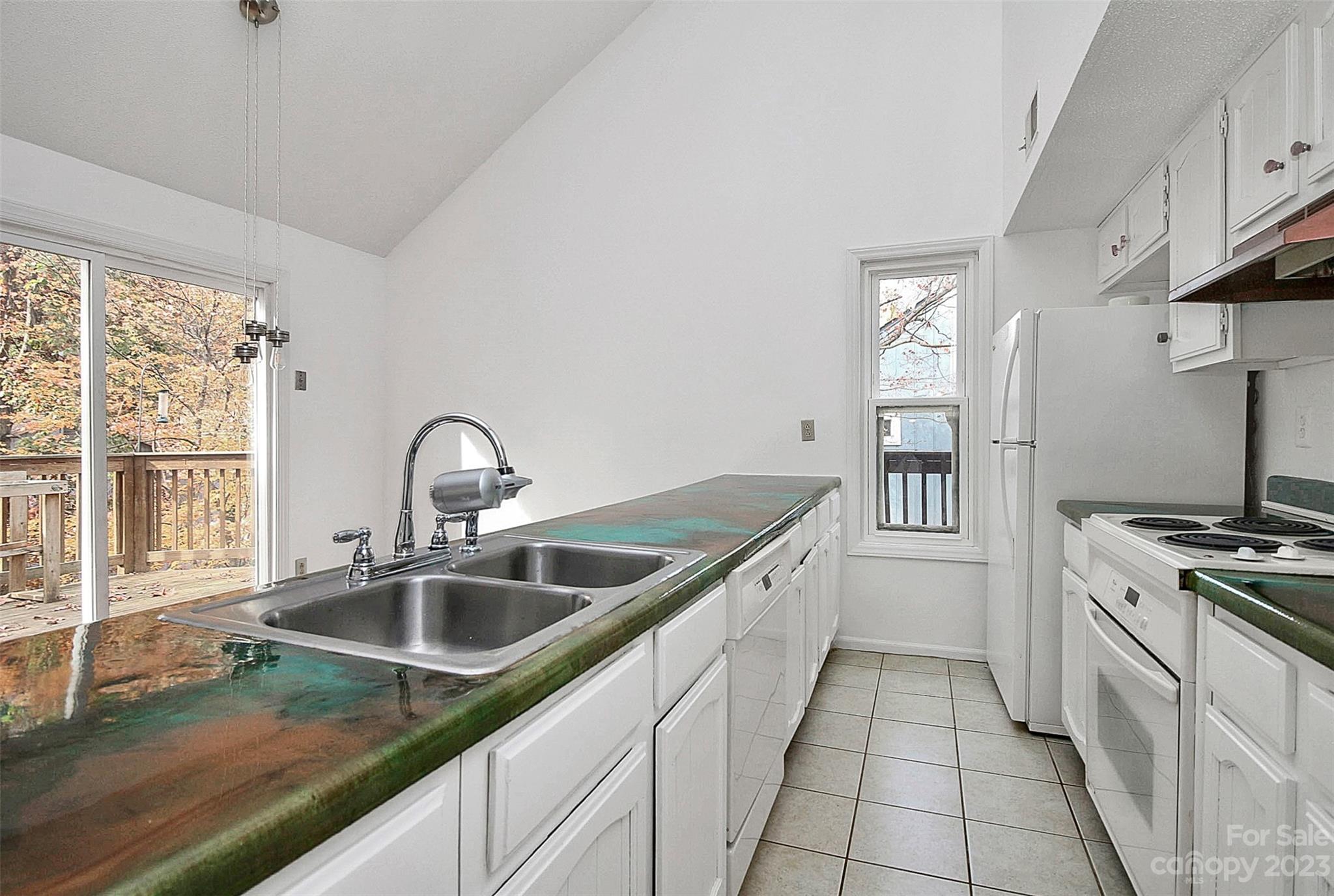 27051 Catamaran Drive Tega Cay, SC 29708 - Photo 26 of 35 a kitchen with stainless steel appliances granite countertop a sink stove and cabinets