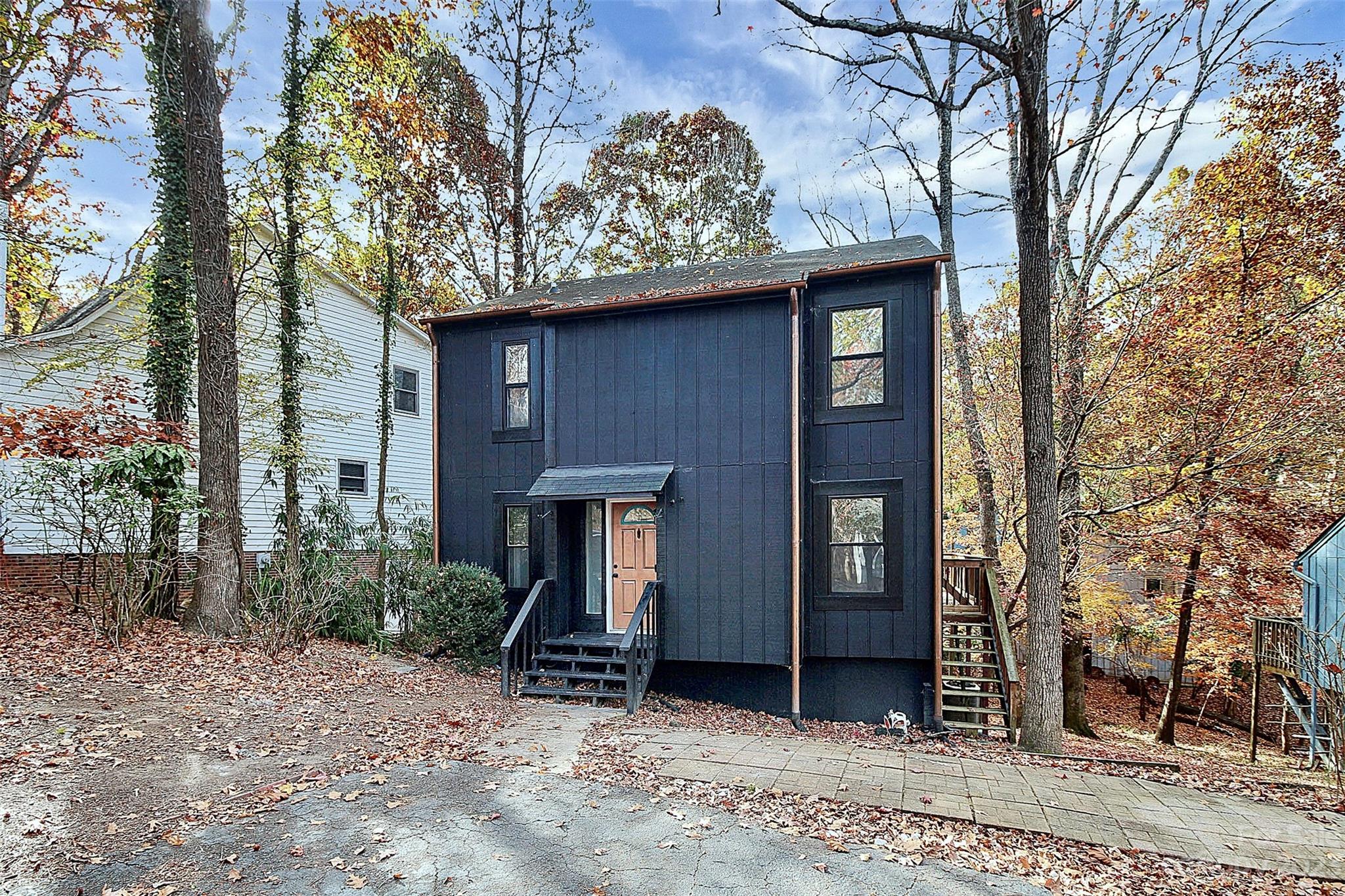 27051 Catamaran Drive Tega Cay, SC 29708 - Photo 4 of 35 a house with a tree in the forest