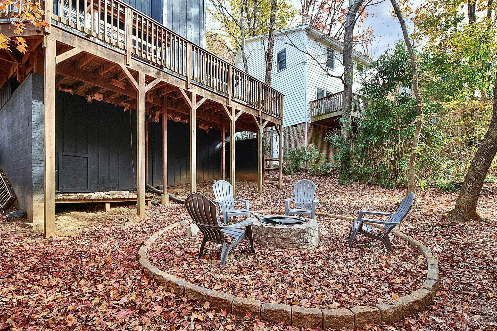 27051 Catamaran Drive Tega Cay, SC 29708 - Photo 6 of 35 a view of a chairs and table in backyard of the house