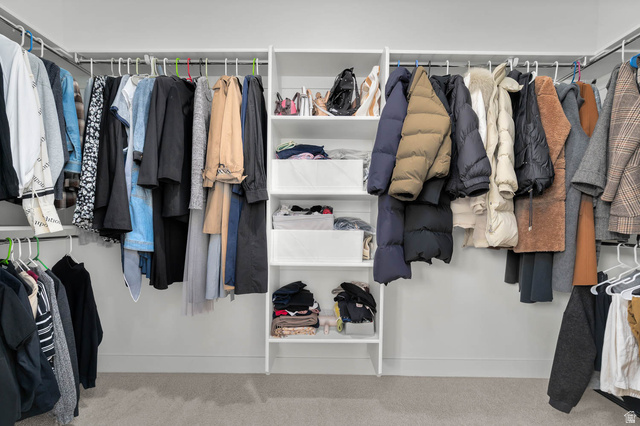 8307 Durham Street Sandy, UT 84070 - Photo 20 of 29 Custom closet system featuring multiple hanging rods, integrated shelving, and light-colored carpeting