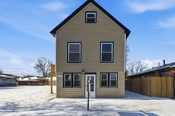 a front view of a house with a road
