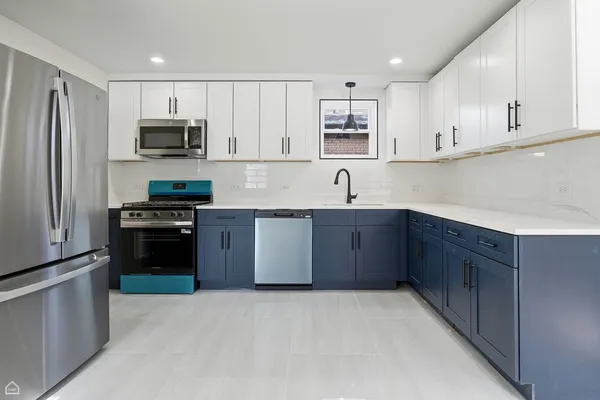 a kitchen with stainless steel appliances granite countertop a refrigerator stove a sink and dishwasher with wooden cabinets