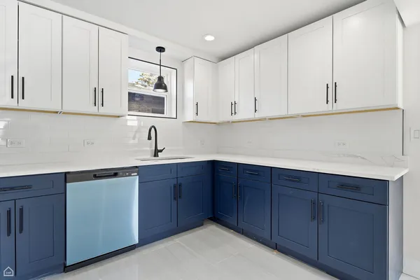 a kitchen with stainless steel appliances granite countertop white cabinets and sink