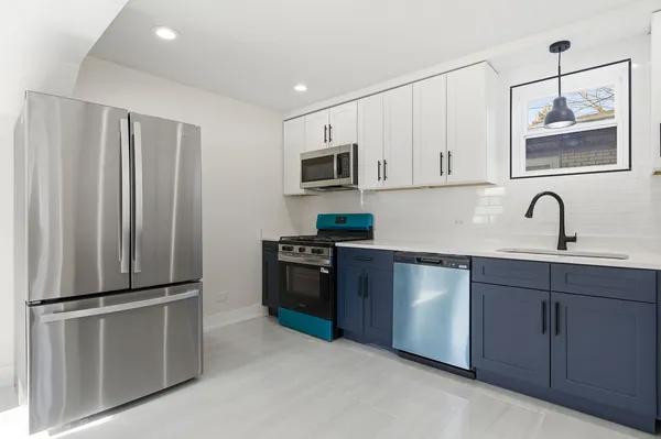 a kitchen with stainless steel appliances granite countertop a refrigerator and a sink