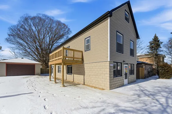 a view of a house with a snow in the yard