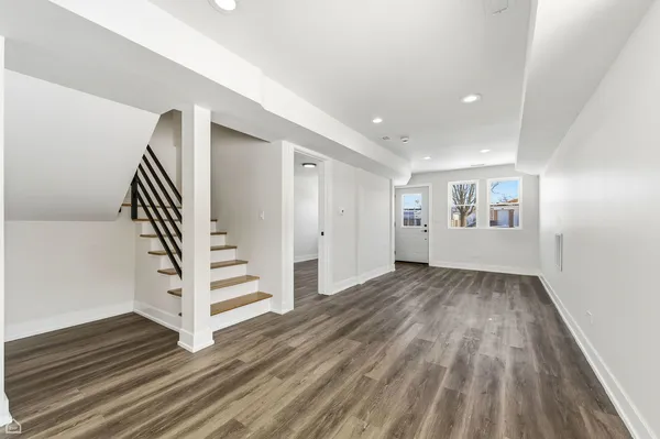 a view of a livingroom with wooden floor and white walls