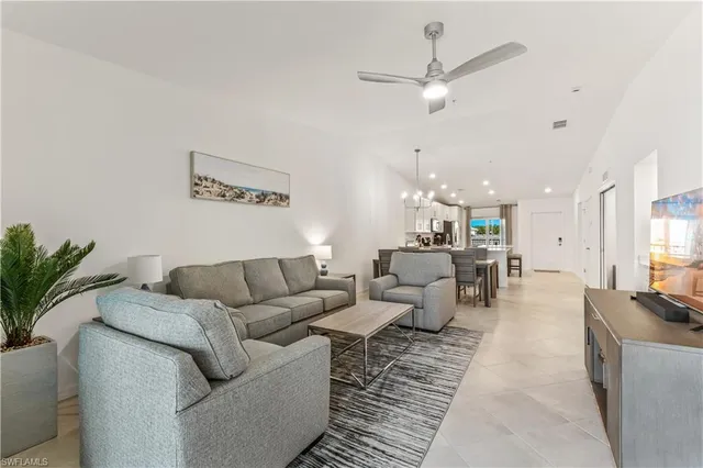 a living room with furniture and a chandelier