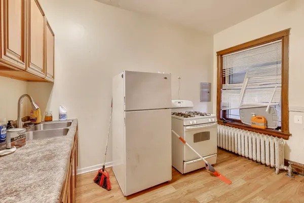 a kitchen with stainless steel appliances a refrigerator and a stove top oven