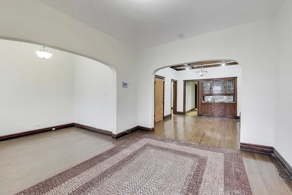 a view of an empty room and wooden floor