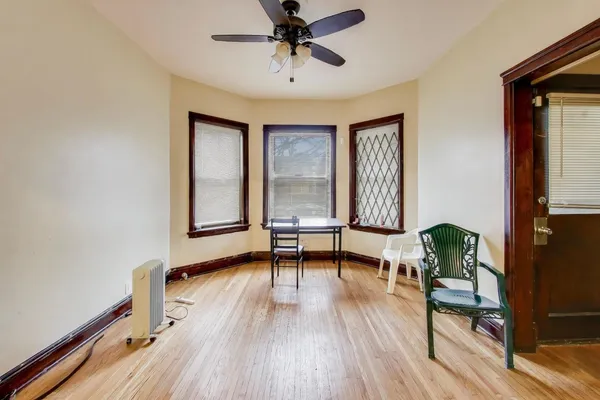 a view of room with wooden floor and gym equipment