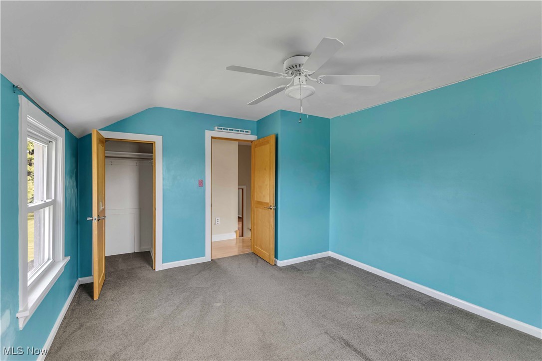 15388 Ridge Road North Royalton, OH 44133 - Photo 16 of 45 Unfurnished bedroom with carpet flooring, vaulted ceiling, a closet, and ceiling fan