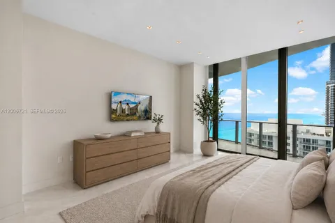 a bedroom with a large bed and a large window