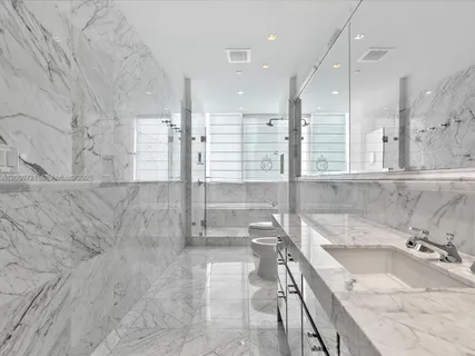 a bathroom with a shower sink and mirror
