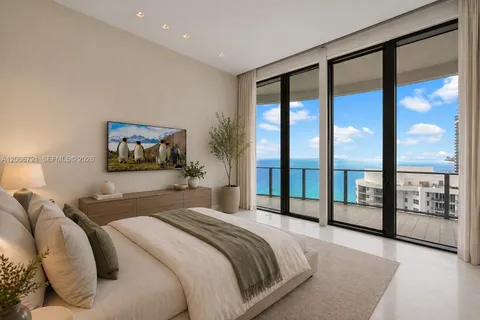 a bedroom with a large bed and a balcony