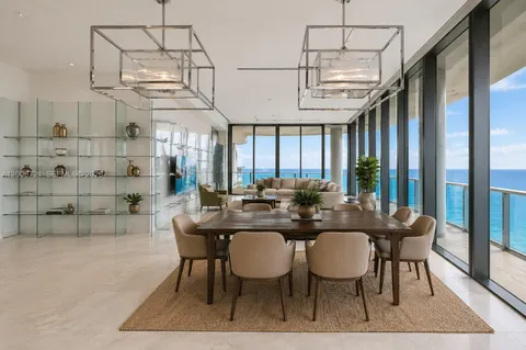 a view of a dining room with furniture a chandelier and wooden floor