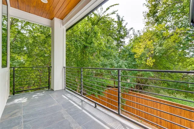 a view of a two chair in the balcony next to a yard