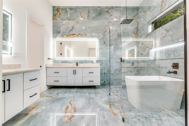 a bathroom with a bathtub sink and mirror