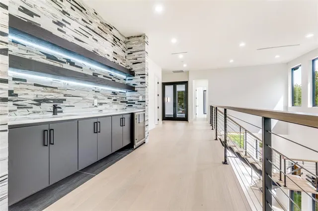 a view of a kitchen with a sink and a large window